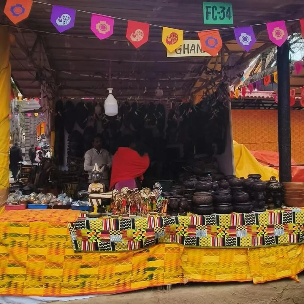 Visitors exploring craft stalls and enjoying performances at Surajkund Mela 2025