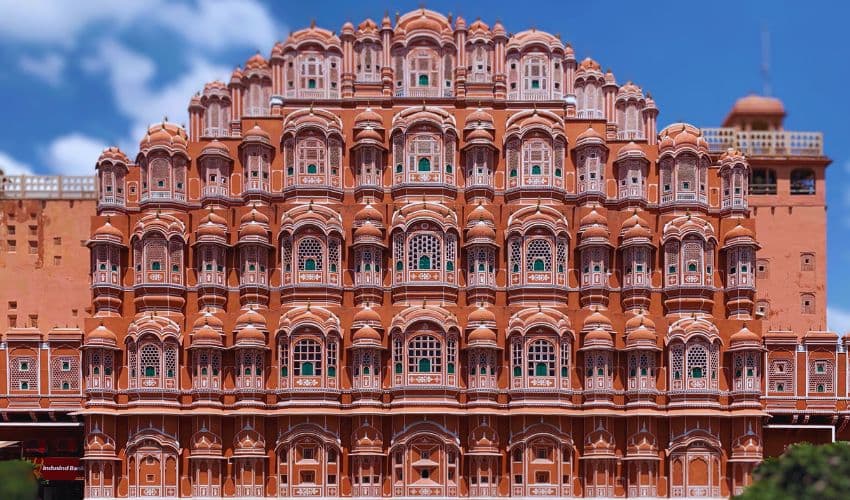 Tourists visiting Hawa Mahal in Jaipur, a must-visit historical site in India.